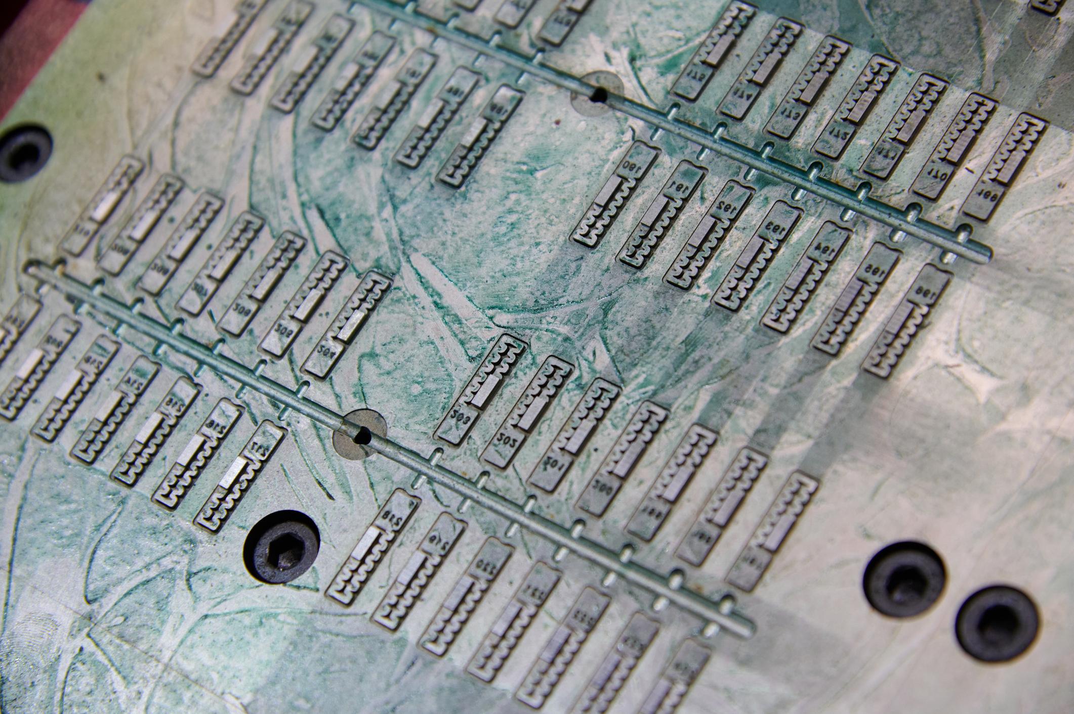 Plastic components on injection mold during manufacturing process.