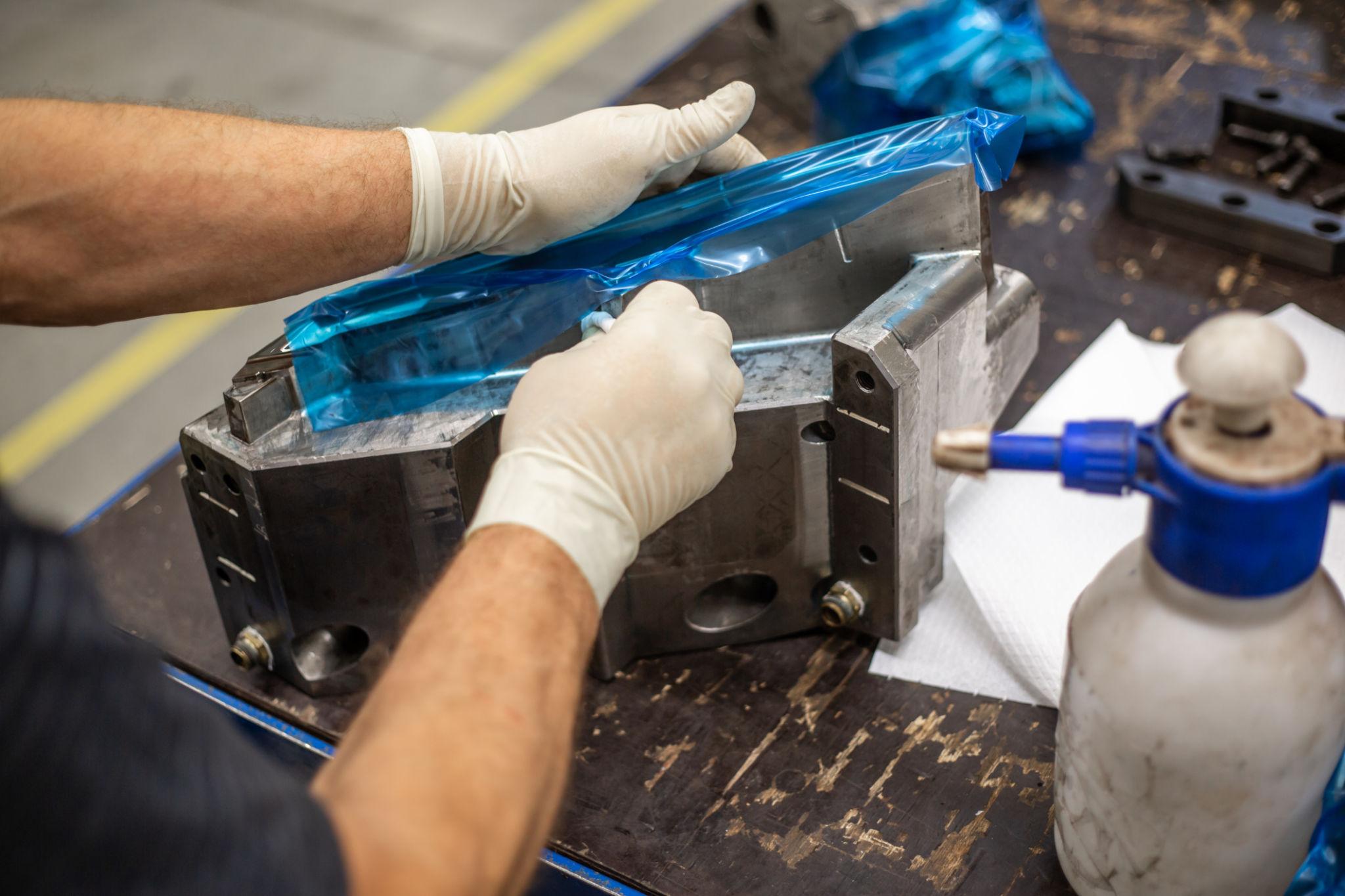 Process of maintenance a parts of a huge mold for plastic moldings, industrial concept.