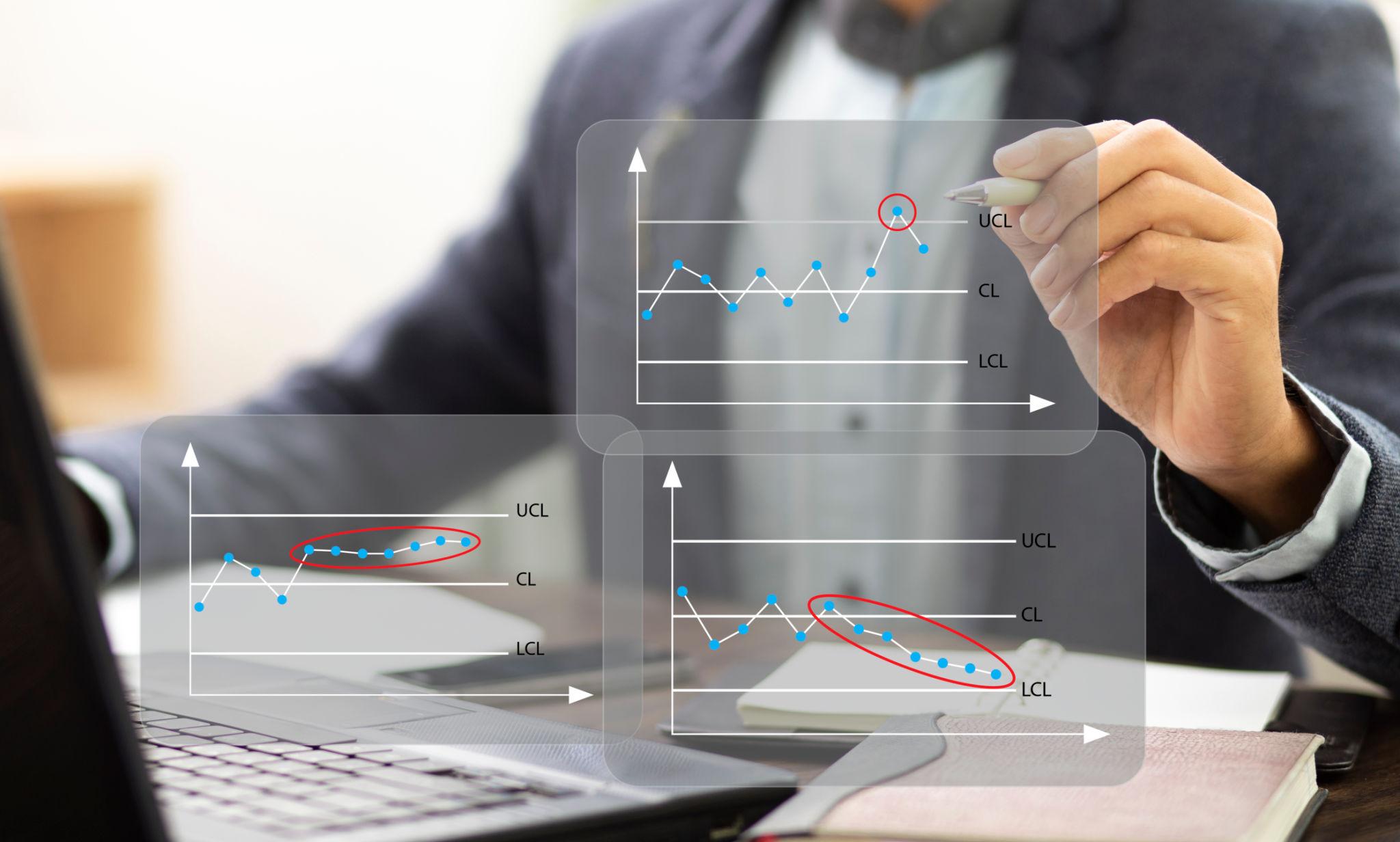 Businessman or trainer write SPC chart control and analysis problem data in process.